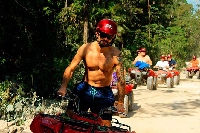 ATV Cenote and Zipline Adventure from Tulum - Riding an ATV over roots, rocks, and uneven ground