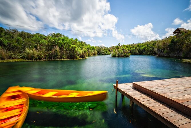 Cenote Tankah and Mayan Village Tour with Zipline, Canoes & Lunch - Swimming through Tankah’s cenotes