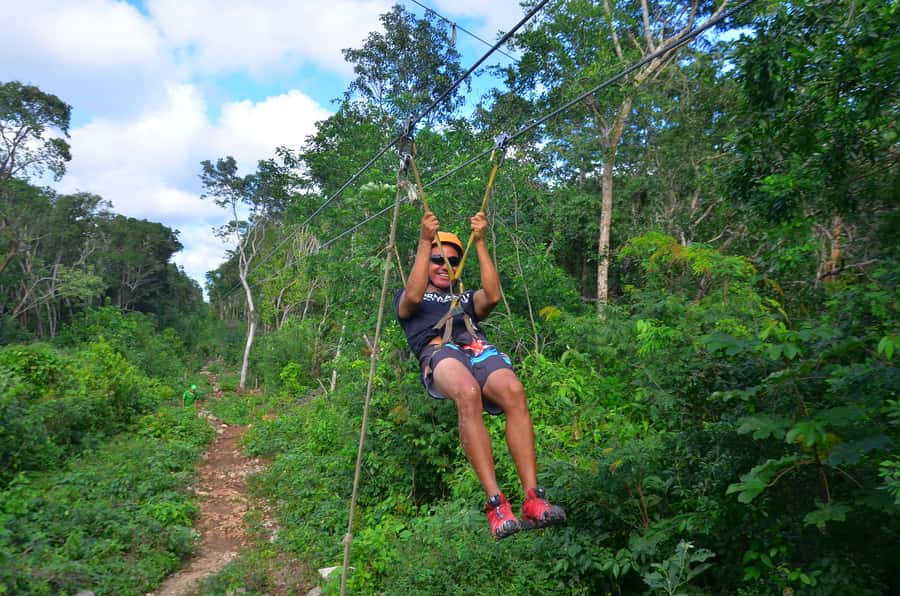 Tulum: ATV, Cenote, Zip lining and Rappelling Experience - A cave cenote lit by daylight and wrist lamps